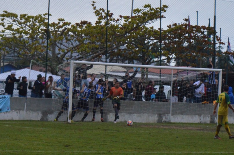 João Vitor buscando a bola dentro do gol, enquanto o Grêmio comemorava com a torcida, ao fundo. (Foto: Lucas Gabriel Cardoso)